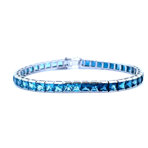"Dreamscape Delights: Lady's White 14 Karat Straight Line Bracelet with Princess Blue Topazs"