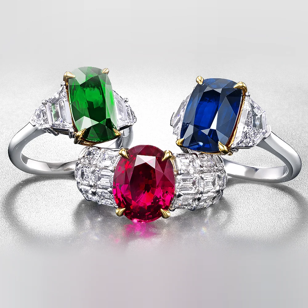 Three rings set with an emerald, a ruby and a sapphire