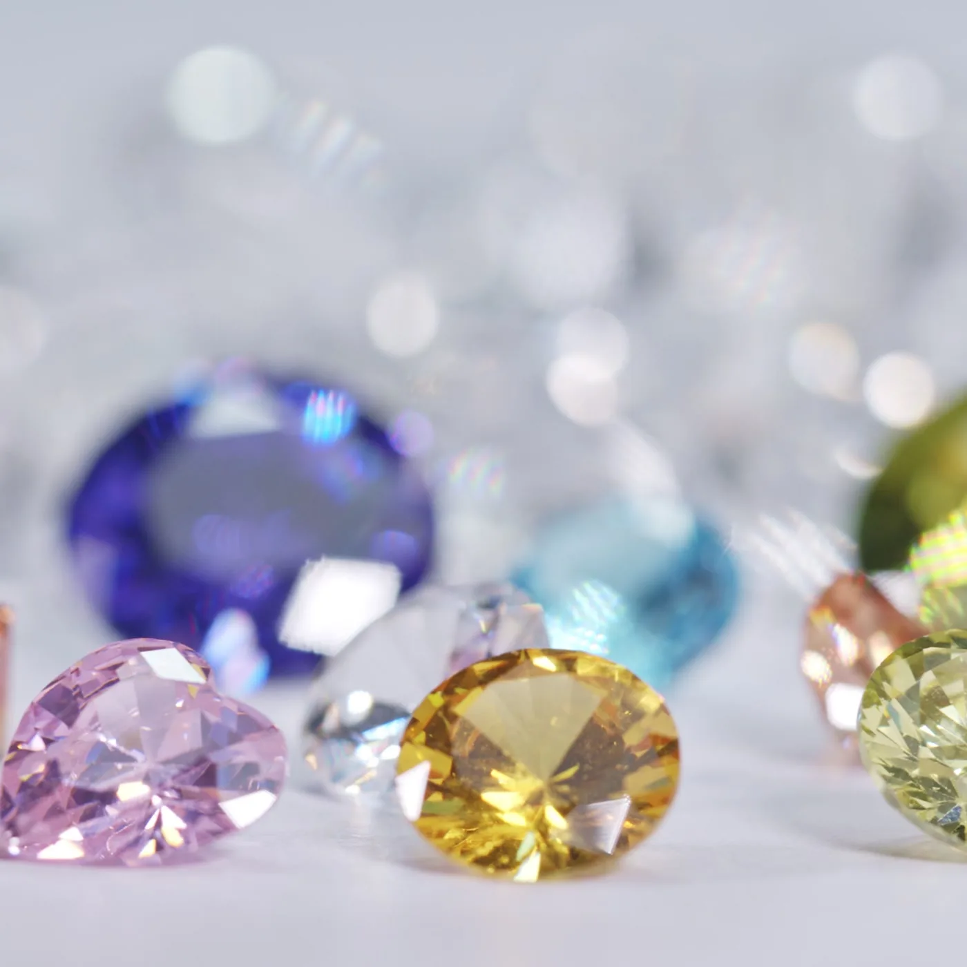 Loose colored gems on a white surface