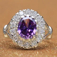 An oval amethyst ring in a halo of diamonds