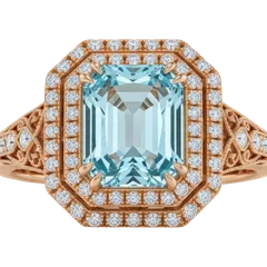 An emerald-cut aquamarine ring in rose gold with a double halo of diamonds