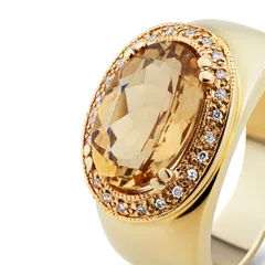 A citrine ring in yellow gold with a halo of diamonds