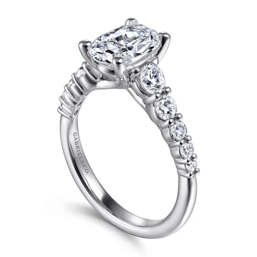 An oval diamond engagement ring in 14K white gold with diamonds along the band, by Gabriel & Co.