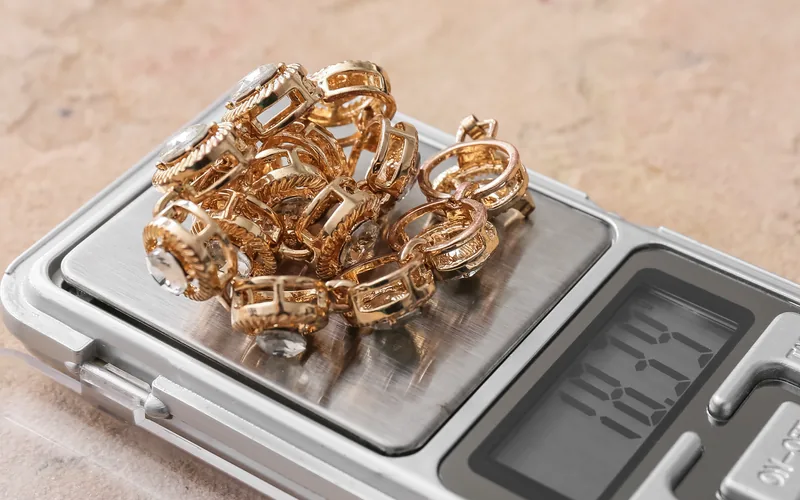 Gold rings heaped on a jeweler’s scale