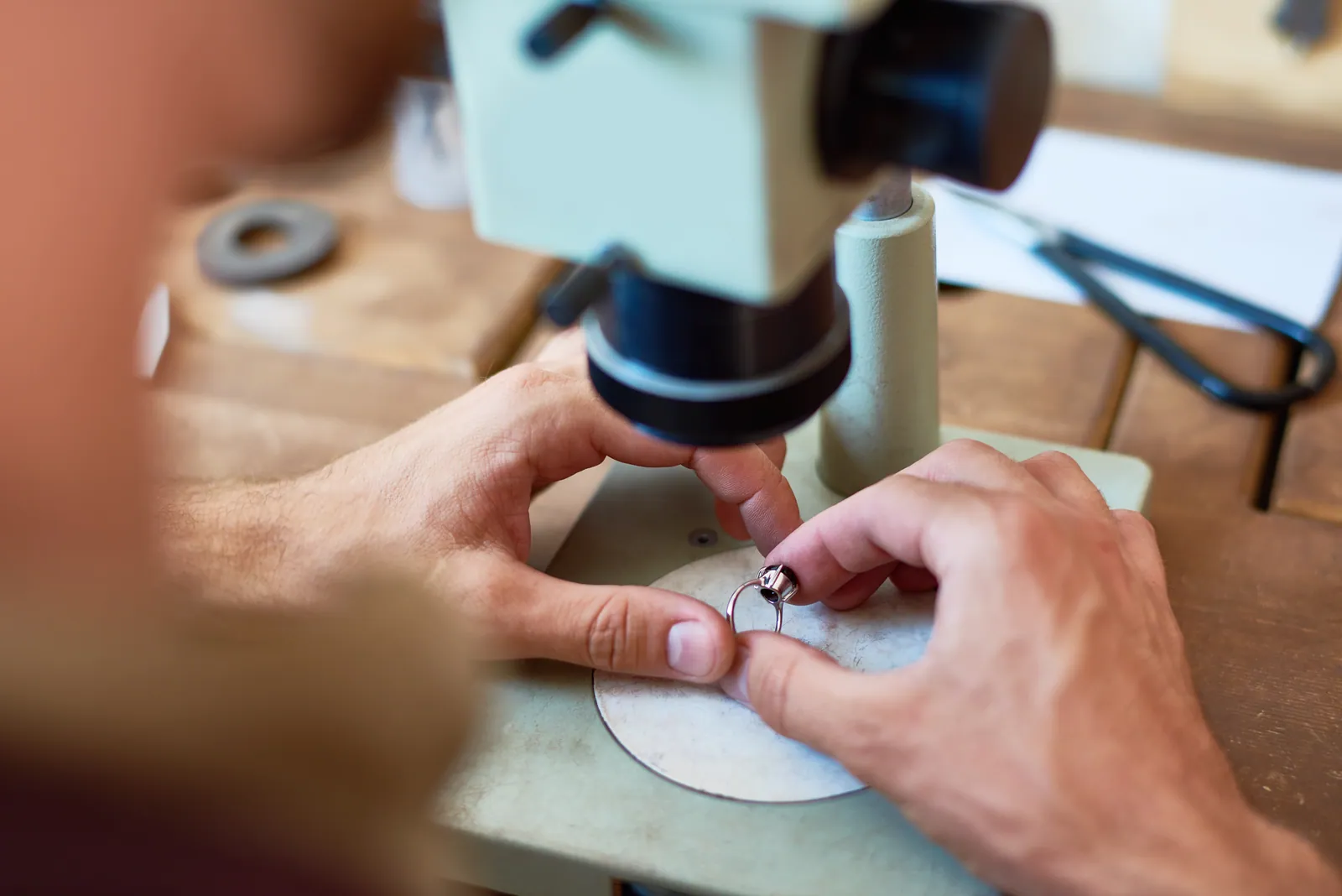 A gem examined under the microscope at the appraisal desk