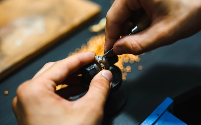 A diamond ring in the clamp while a setting is worked