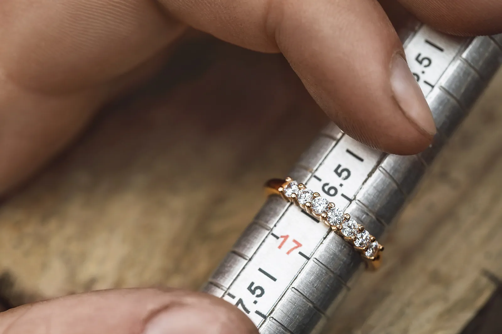 A diamond band resting on the ring gauge