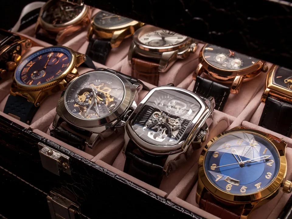 A collector&rsquo;s case open on its cushions, eight watches waiting to be looked through