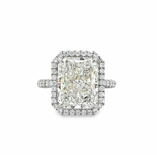 Lady's White Platinum Traditional Halo With Pave' Set Band Ring one = 7.41ct Radiant K SI1 Diamond
116 = 1.40tw Round G/H VS2 Diamonds