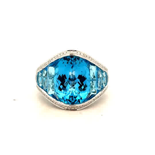 Lady's White 14 Karat Oval, Graduating Fashion Ring one = 7.01ct Oval Blue Topaz
= 4.19tw Various Shapes Blue Topazs
= 0.23tw Round G/H SI1 Diamonds
