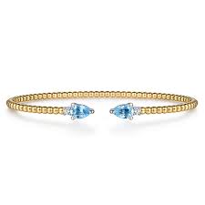 Lady's White/Yellow 14 Karat Bujukan Collection, Open Cuff Bracelet Length 6.25 With 2 = 1.05Tw Pear Blue Topazs And = 0.09Tw Round G/H Si2 Diamonds