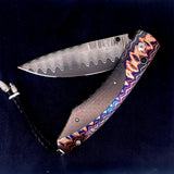 The Spearpoint 'Midnight Sky' William Henry Knife with 'Wave' Mokume Gane and Carbon Fiber Details, and 'Wave' Damascus Steel Blade.