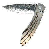'Golden Arch' William Henry Knife with Hand Forged 'Wave' Damascus Blade with VG-10 Core and Blast-Finished Aerospace Grade Titanium Frame with Anodized Gold Accents.
