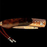 William Henry Knife The Spearpoint 'Rustic' features a beautiful frame in William Henry's signature (and patent pending) 'Wave' Mokume, inlaid with a stunning scale in desert ironwood. The blade is 'copper wave' damascus steel with an extra sharp core in