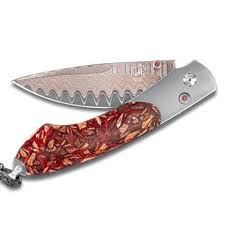William Henry Knife The Spearpoint ‘Blend’ features a frame in aerospace-grade titanium, inlaid with a scale made from Pinot Noir chips. The blade is William Henry's signature 'Copper Wave' blade with a VG-5 core. The one-hand button lock and the thumb st