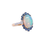 Lady's Yellow 14 Karat Oval Halo Fashion Ring With One 3.09Ct Oval Opal, 0.11Tw Round G/H Si1 Diamonds And 0.9 Twt Other Stones