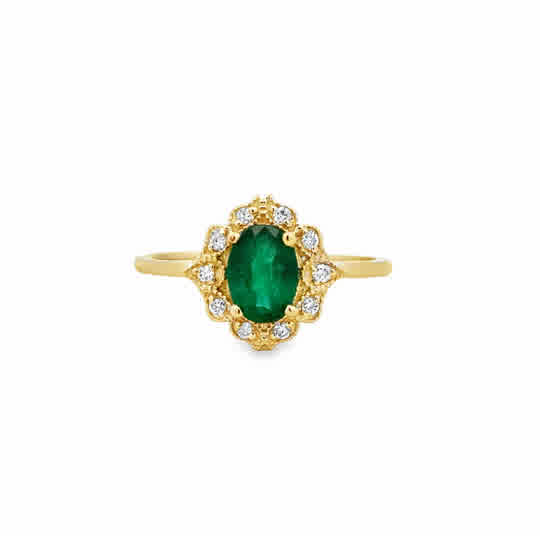 14 Karat Yellow Gold Vintage Inspired Ring with an Oval Cut Emerald, and Round Brilliant Cut Diamonds