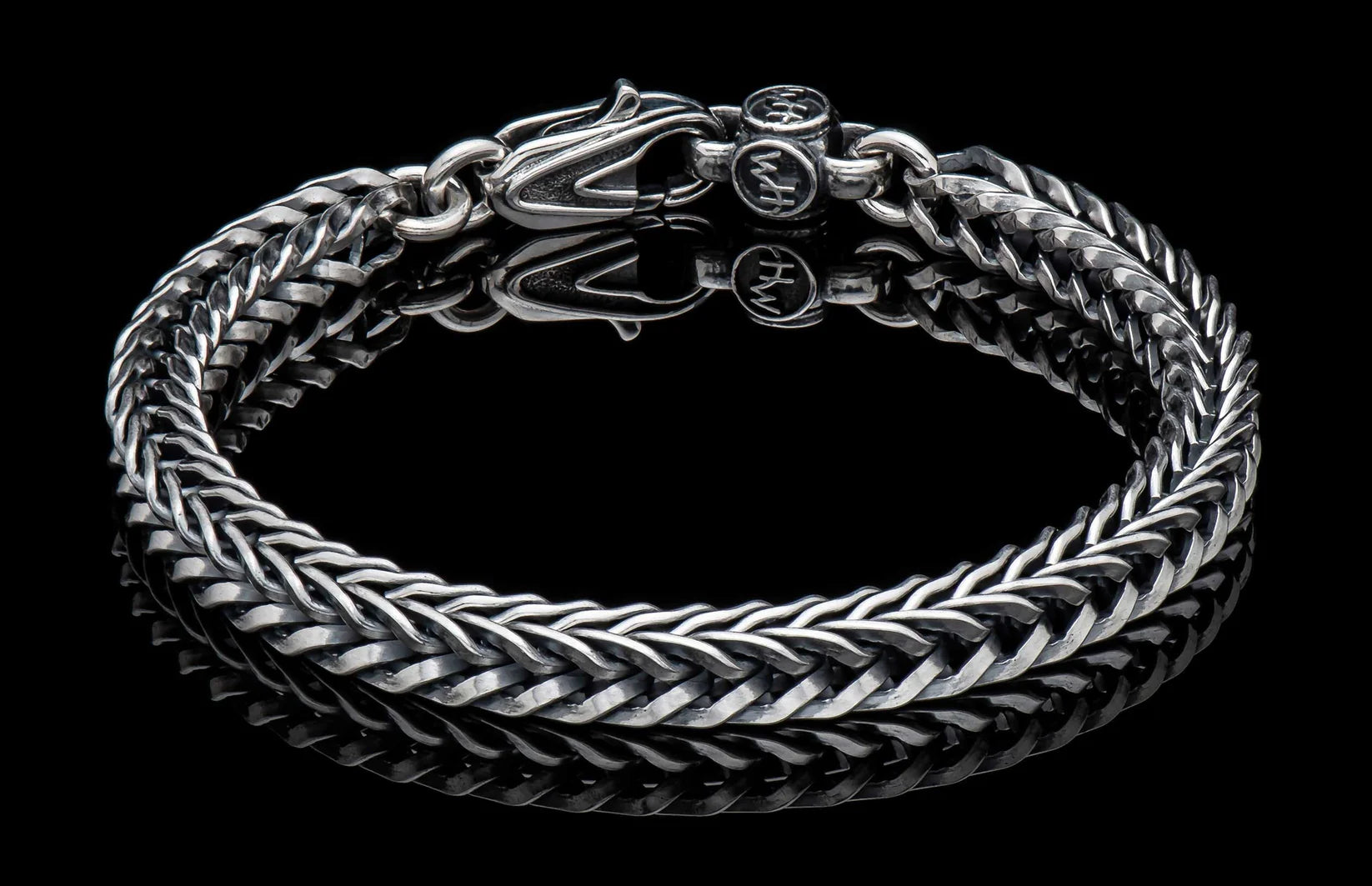 Bold, supple, fluid, snakelike, this foxtail chain bracelet  in sterling silver is in a league of its own. Beautifully oxidized and hand polished, this complex pattern flows around the wrist and draws the eye closer. There are a great many foxtail pattern