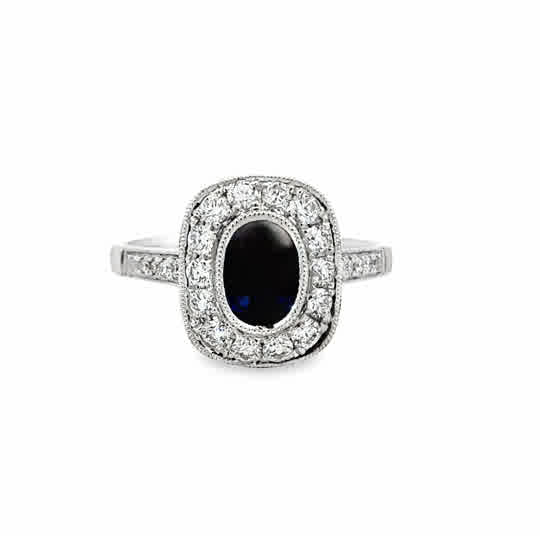 18 Karat White Gold Vintage Halo Fashion Ring with 1.28ct Oval Cut Sapphire and .66ctw Round Brilliant Cut Diamonds