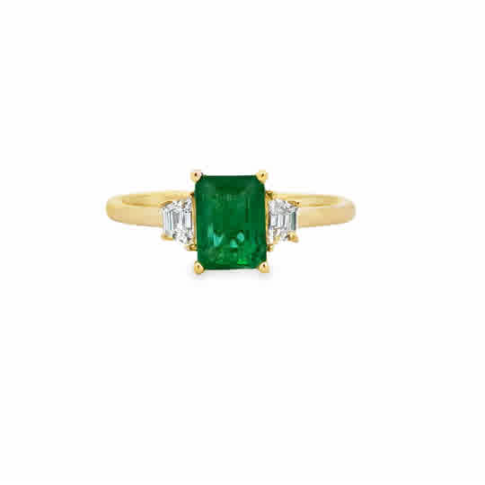 14ky Three Stone Ring with an Emerald Cut Emerald, and Trapezoid Cut Diamonds