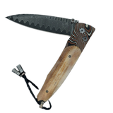 William Henry Knife The Gentac ‘Eventide’ features a beautiful frame in hand-forged 'Twist' mokume gane, inlaid with bark, or outer section, of a 10,000 year-old fossil Woolly Mammoth tusk . The blade is 'Wave' damascus steel with a VG-10 core; the one-ha