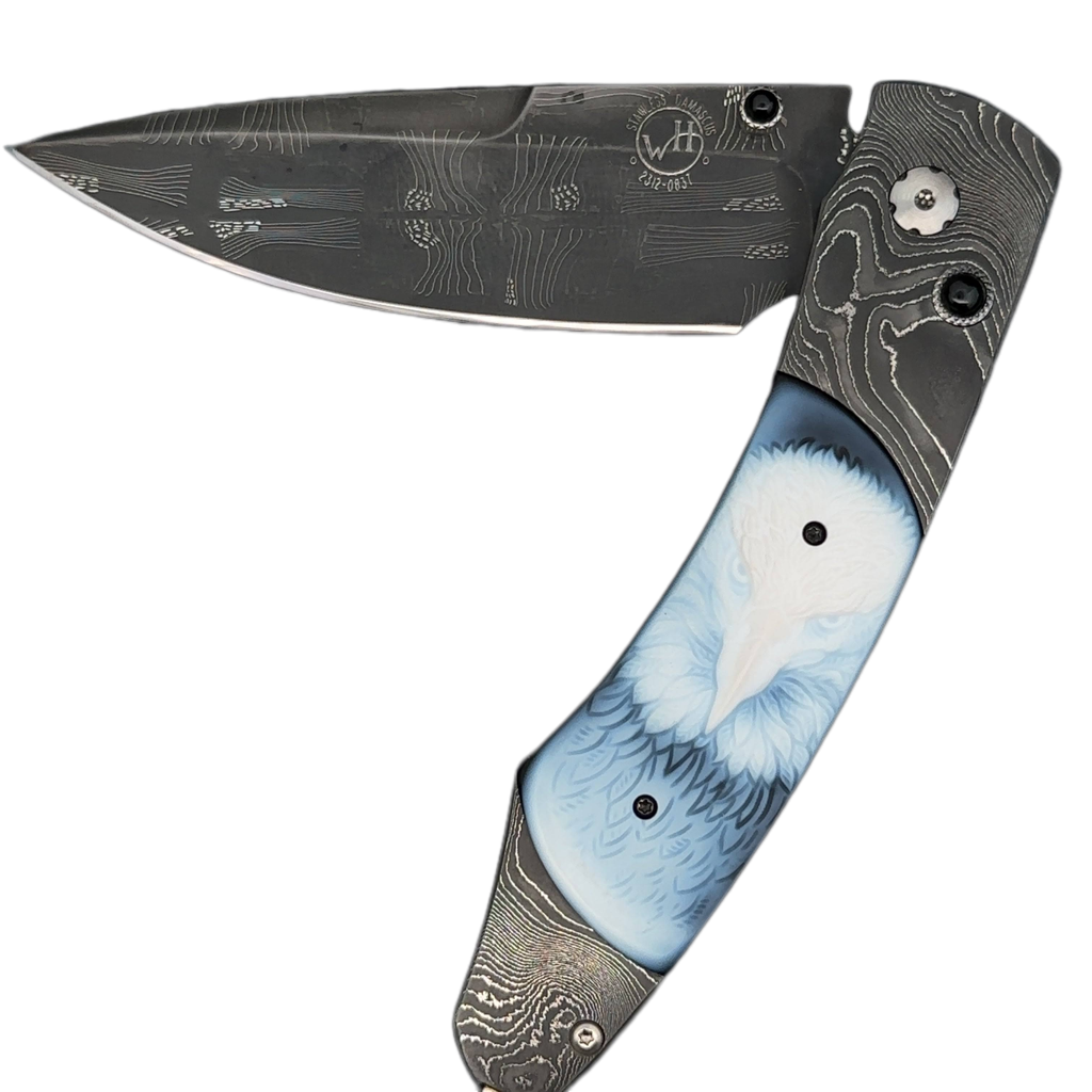 William Henry Knife The Spearpoint 'Dignity' features a frame of hand-forged 'Twist' damascus by Chad Nichols, inlaid with beautiful carved banded agate scales. The blade is hand-forged 'Flag' damascus by Chad Nichols; the one-hand button lock and the thu