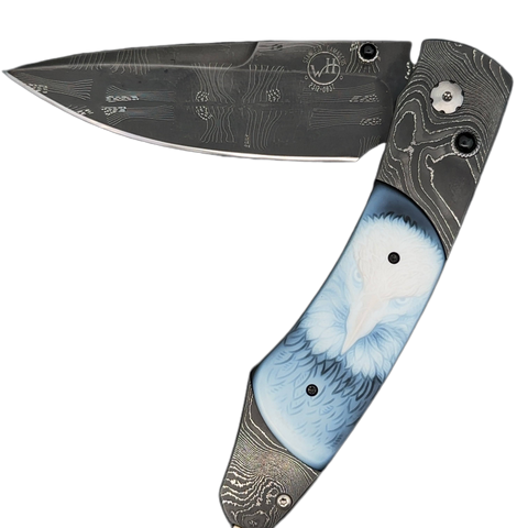 William Henry Knife The Spearpoint 'Dignity' features a frame of hand-forged 'Twist' damascus by Chad Nichols, inlaid with beautiful carved banded agate scales. The blade is hand-forged 'Flag' damascus by Chad Nichols; the one-hand button lock and the thu