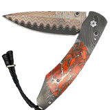 William Henry Knife The Spearpoint ‘Liquid Sky’ features a frame in hand-forged 'Twist' damascus by Chad Nichols, inlaid with Zinc Matrix apple coral. The blade is 'Copper Wave' damascus with a VG5 core; the one-hand button lock and the thumb stud are set