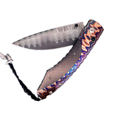 The Spearpoint 'Midnight Sky' William Henry Knife with 'Wave' Mokume Gane and Carbon Fiber Details, and 'Wave' Damascus Steel Blade.