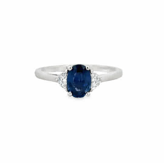 Platinum Three Stone Ring with an Oval Cut Sapphire, and Half Moon Cut Diamonds