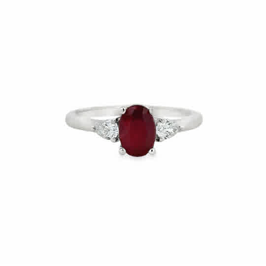 Platinum Three Stone Ring with an Oval Cut Ruby, and Pear Cut Diamonds